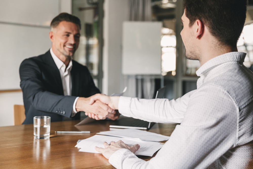 interviewee shaking hands; Top Advice About Hiring Outstanding Talent